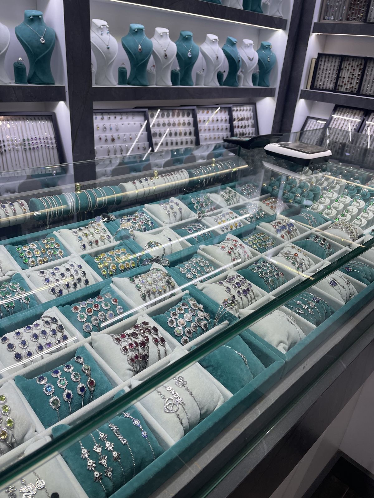 Atlanta jewelry salon with chandelier and gemstone displays.